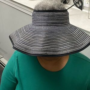 Like new visor hat. Black with silver. Bow accent.